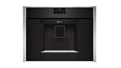 Black fully automatic coffee machine with metallic details on a white background.