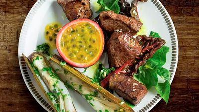 Grilled meat with a passion fruit in the middle of the plate