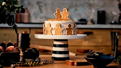 A cake with small gingerbread figures around