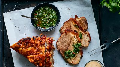 Sliced roast prok and crackling with black beer sauce and chimichurri