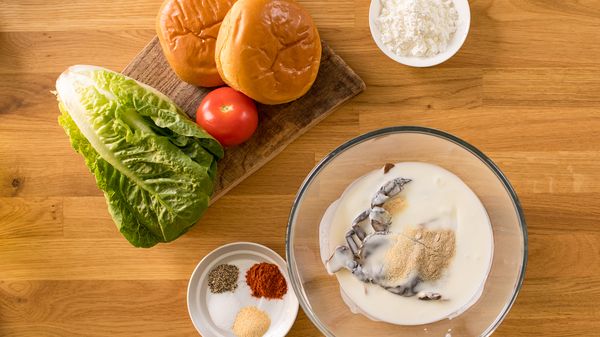 Crab marinating in a bowl surrounded by other ingredients on counter top