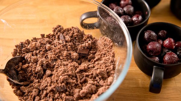 Cocoa crumble mixture ready in clear bowl