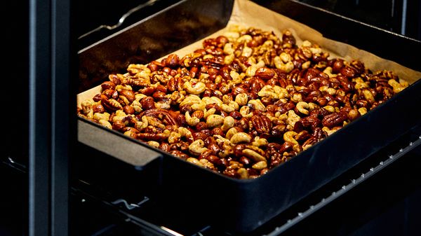 Nuts cooking in oven on baking tray