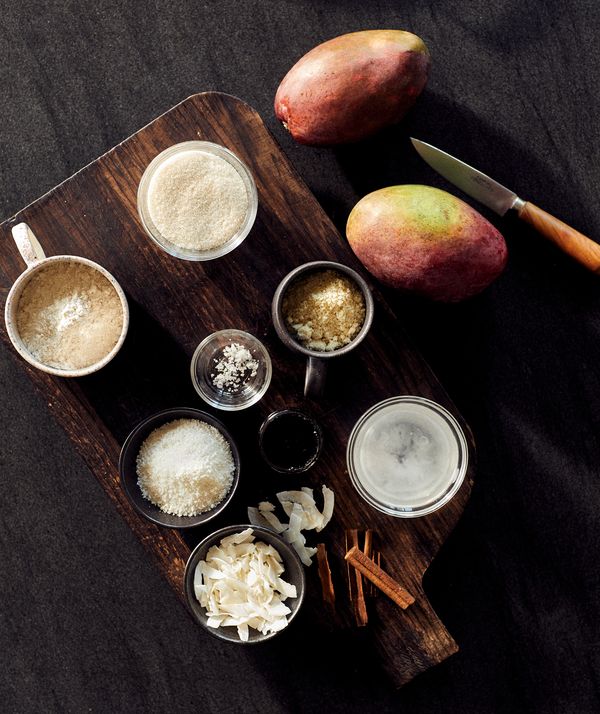 Numerous individual ingredients for grilled mango and coconut cumble on counter top