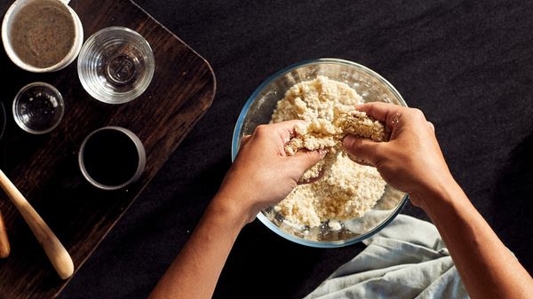 Multiple ingredients being hand mixed in a bowl