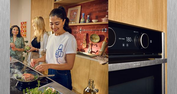 Anahita cooking with friends, close-up of Slide & Hide ® oven with two Twist Pads ® 
