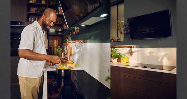 Kuva Chris Glass lähellä antrasiitin harmaata keittotasoa ja lähikuva viistosta liesituulettimesta 