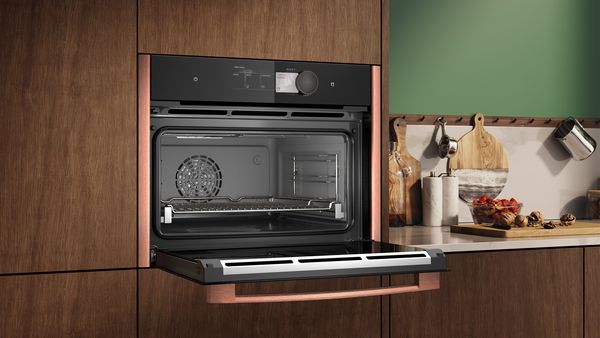 Microwave with Brushed Bronze side strips, shown with door open  