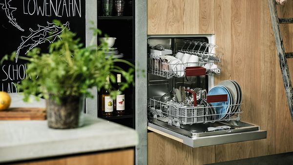 A fully-integrated dishwasher at a convenient working height with an open door and two baskets pulled out