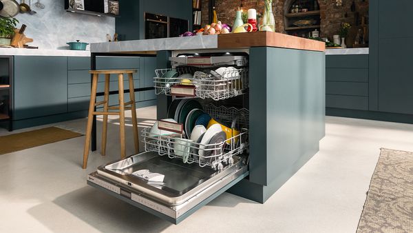 An open 60 cm-width dishwasher incorporated into a kitchen island