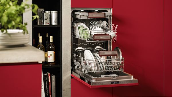 A 45 cm dishwasher fully-integrated at a convenient working height with an open door