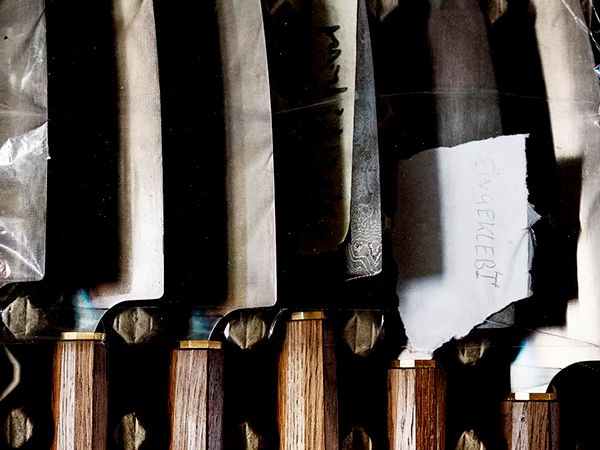 5 hand-made and oak-handled kitchen knives next to each other