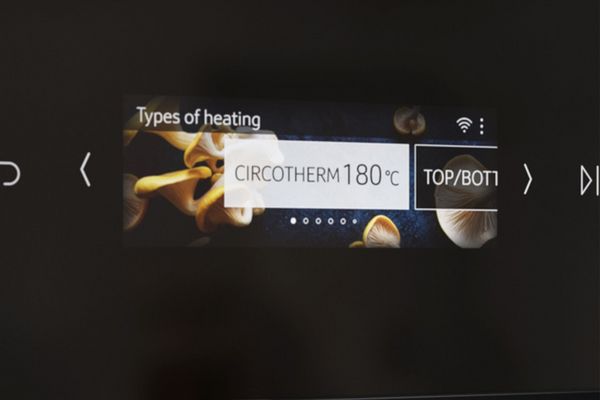 Close-up of NEFF oven display set to 180°C.