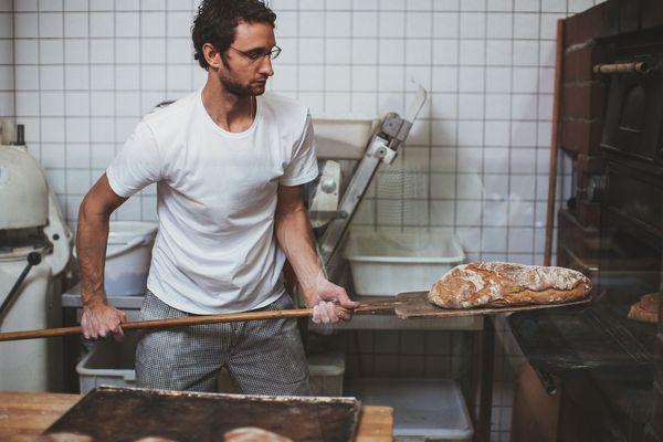 Load of bread being put in the oven