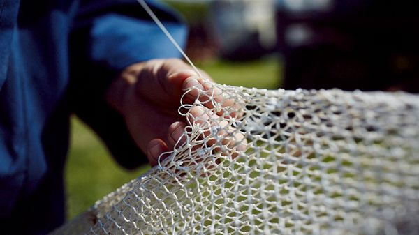 Man tying a fishing net