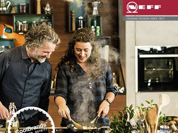 Man and women cooking with NEFF appliances