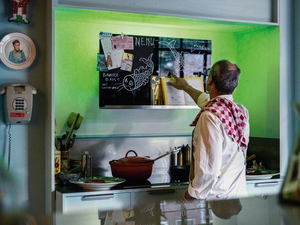 Man using NEFF Creative Slim Hood bulletin board feature for recipe ideas