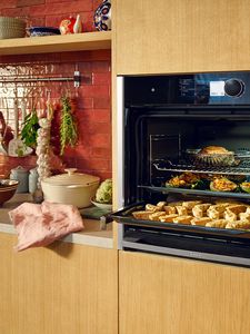 Open Slide & Hide oven showing 3 trays of food, link to Slide & Hide ovens  