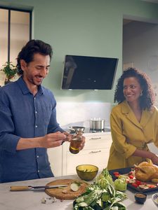 People cooking in ktichen with extractor on wall