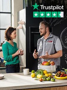 Neff service specialist talking to woman in kitchen