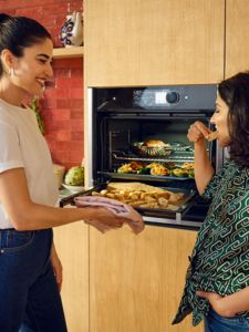 Women chatting in the kitchen near the oprn neff oven