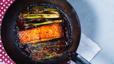 Fresh miso-glazed salmon served with steamed broccoli and rice on a white plate.     