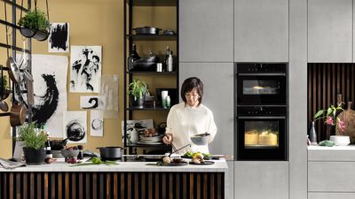 A kitchen with a vertical theme and earthly colours bamboo 
