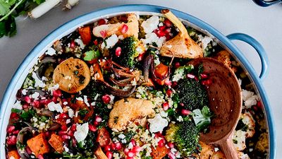 A winter salad with tabbouleh and roasted vegetables in a big blue pot