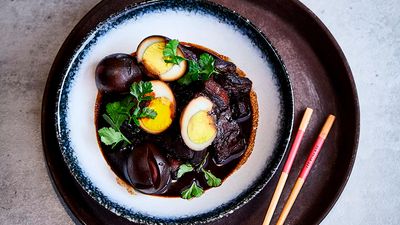 Boiled eggs, fermented tofu and pork belly pieces in a delicious dark soy sauce on a plate