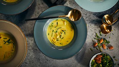Ras malai: A popular Indian sweet delicacy in a blue plate and a golden spoon next to it