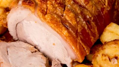 Sliced roast pork and crackling with apple sauce, roas potatoes and gravy