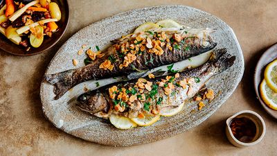 Two juicy trouts cooked and presented on a ceramic plate ready for serving.