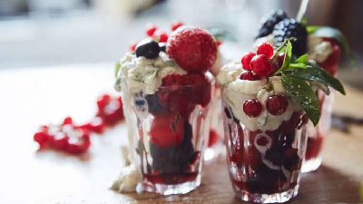 Dolci ai frutti di bosco con panna montata e menta. 