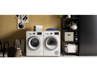 A kitchen featuring a washing machine beside a sink, showcasing a functional and practical home environment.  