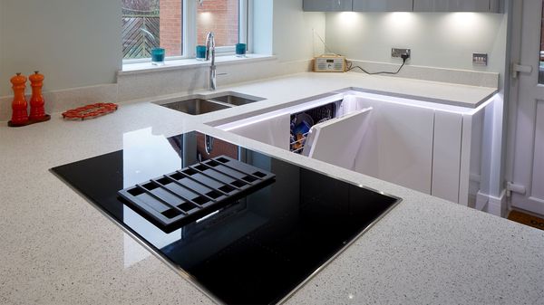 Black vented hob in clean white kitchen