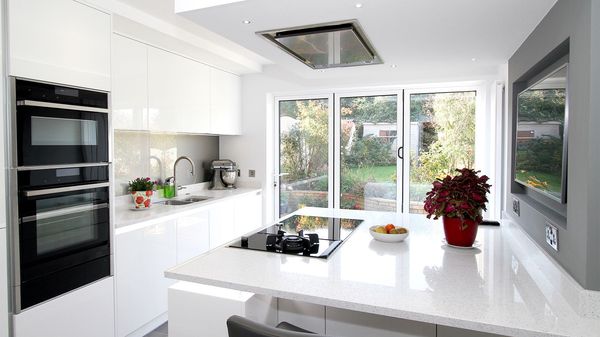 White clean kitchen with domino hob and built-in oven