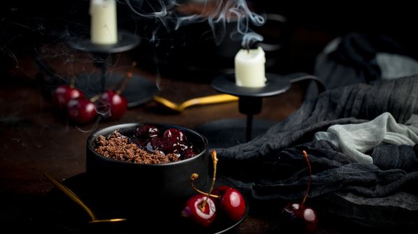 Witches crumble recipe in a bowl surrounded by Halloween decorations