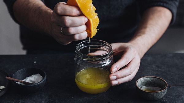 Squeezing orange in a jar