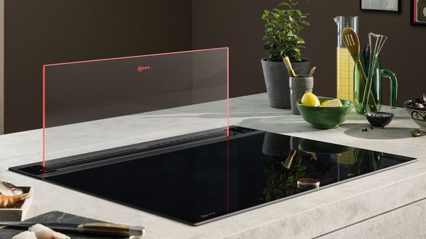 A kitchen island that contains an induction hob with a Glassdraft system.