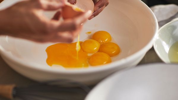Breaking egg yolks into a bowl