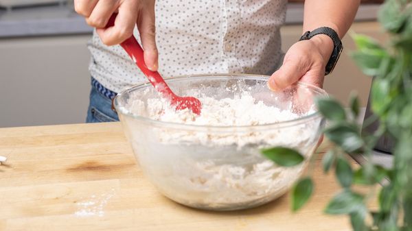 Person mixing the dry ingredients in a bowl