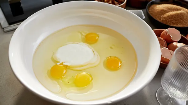 Eggs, oil and yogurt in a bowl