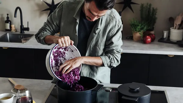 Pouring cabbage into a saucepan