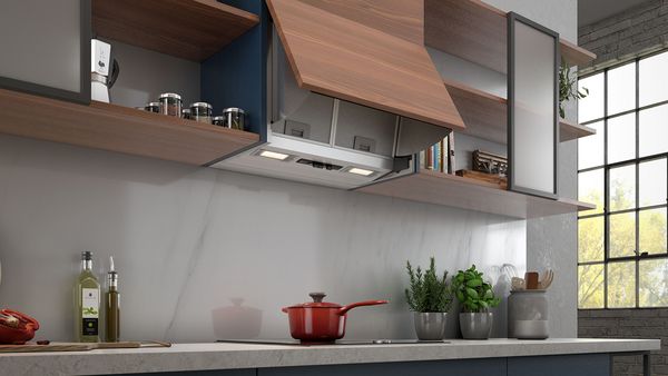 White integrated cooker hood, brown wooden opened cupboard 