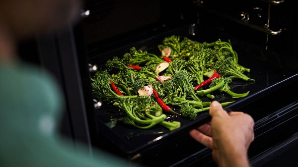 Preheat oven, roast seasoned broccoli, garlic, and chillies