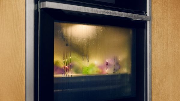 Close-up of N90 Metallic Silver oven showing Intensive Steam behind the steamed up oven door  