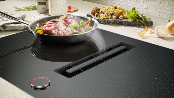 Hob with integrated extractor in use.