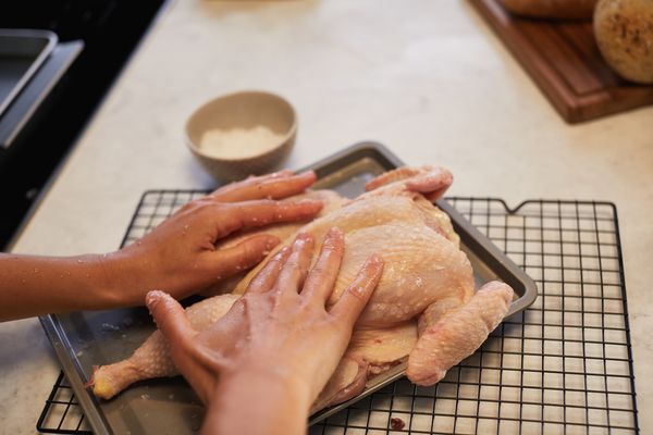 Press two hands on the chicken until it lays flat to spatchcock