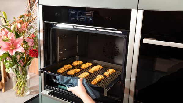 Placing the Fish fingers on an Air Fry & Grill Tray in the oven