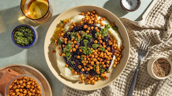 Red Cabbage Steak with Crispy Chickpeas and Cauliflower puree served on a plate 